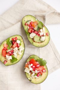 3 avocados stuffed with tomatoes and cheese