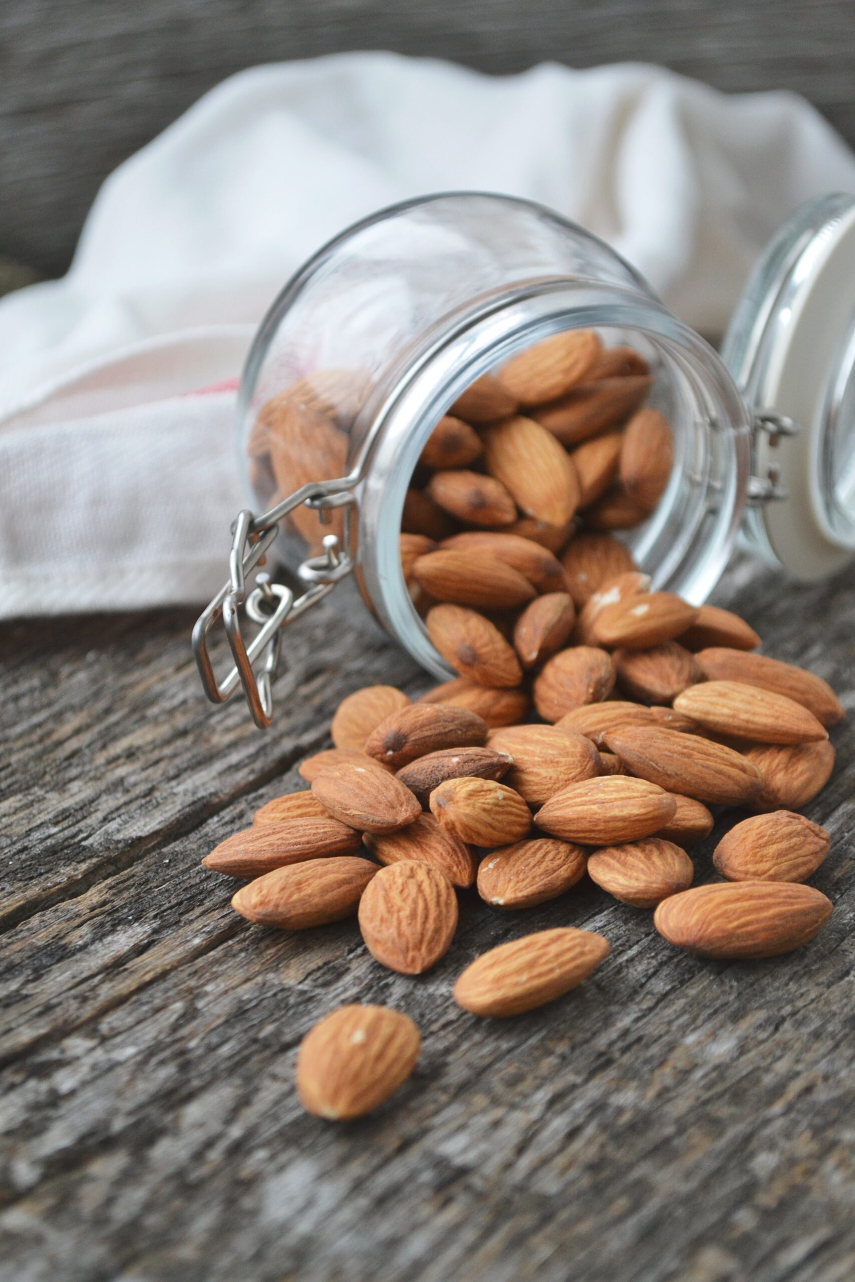 almonds falling out of a glass jar