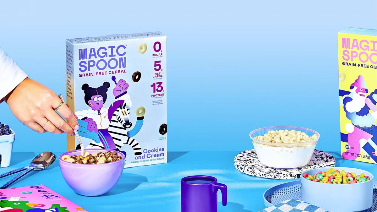 box of keto friendly Magic Spoon cereal and bowls filled with purple cup on table