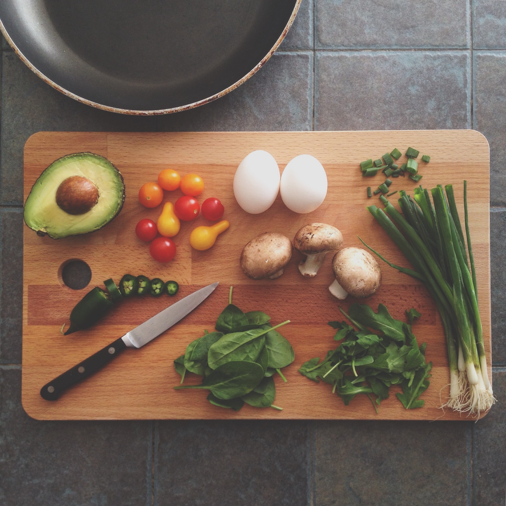 avocado, onions, eggs, spices, mushrooms on a cutting board
